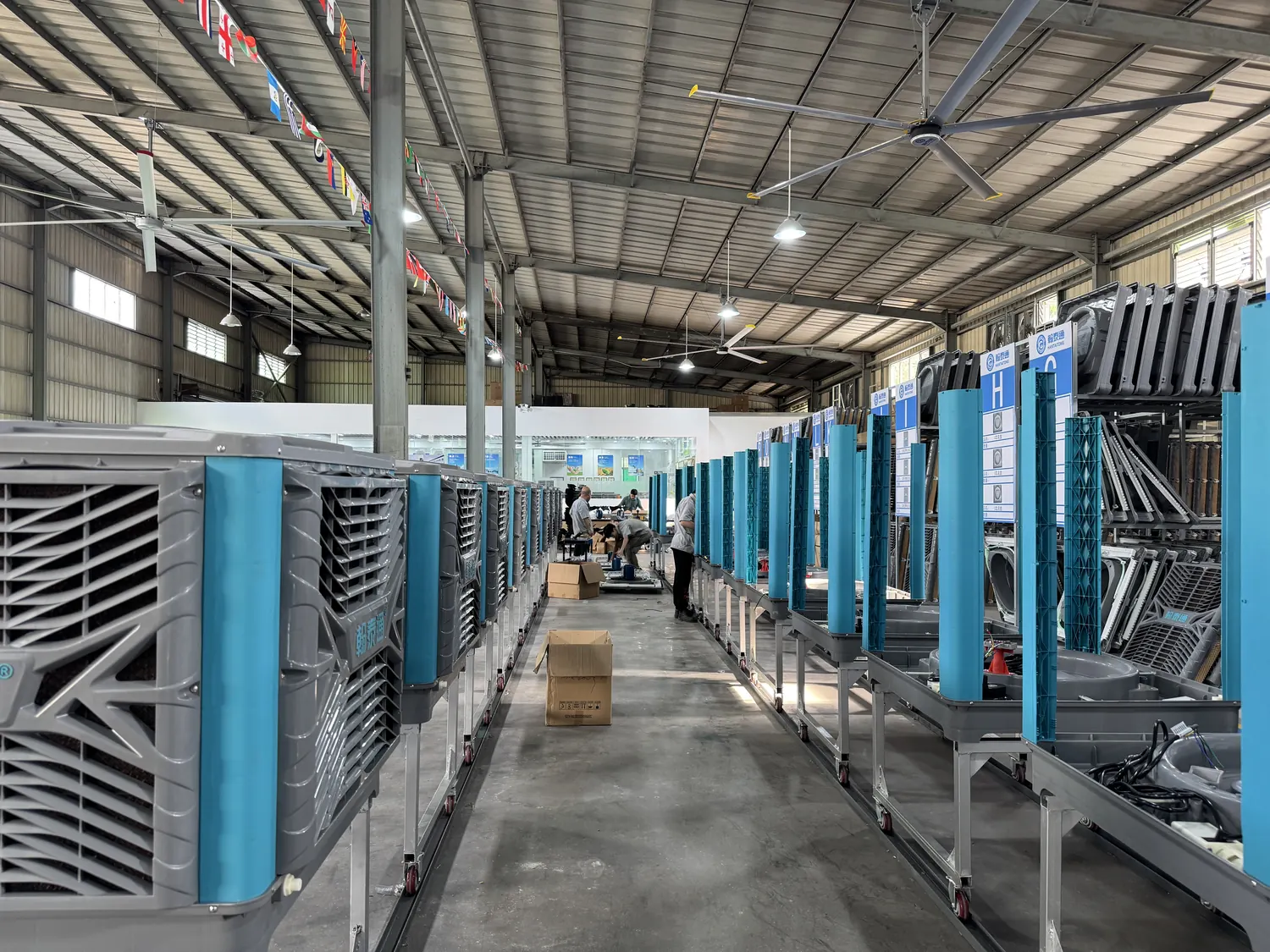Evaporative air cooler cooling pad line with assembly workers